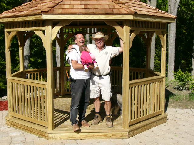 wooden 12 foot octagon gazebo with happy friends standing in the front
