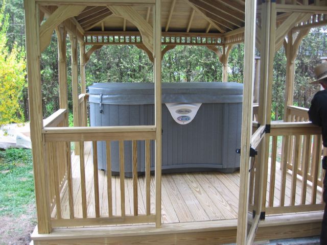 wooden 12 by 16 foot rectangle gazebo with hot tub